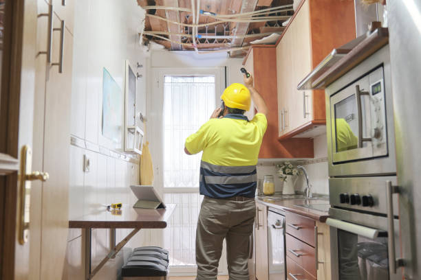 Plumber assessing damage from a broken pipe. Water leakage